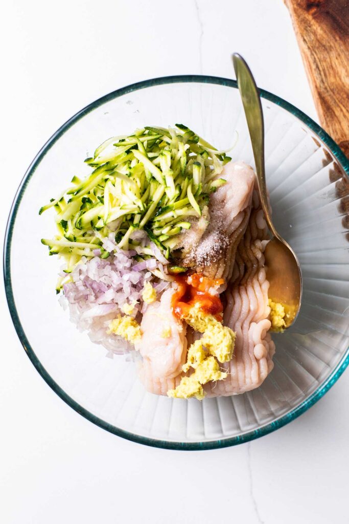 The ingredients for Thai chicken meatballs shown in a bowl.