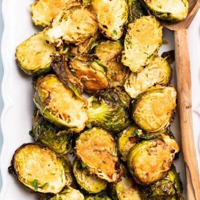 Golden brown brussels sprouts shown with a thick parmesan cheese crust.