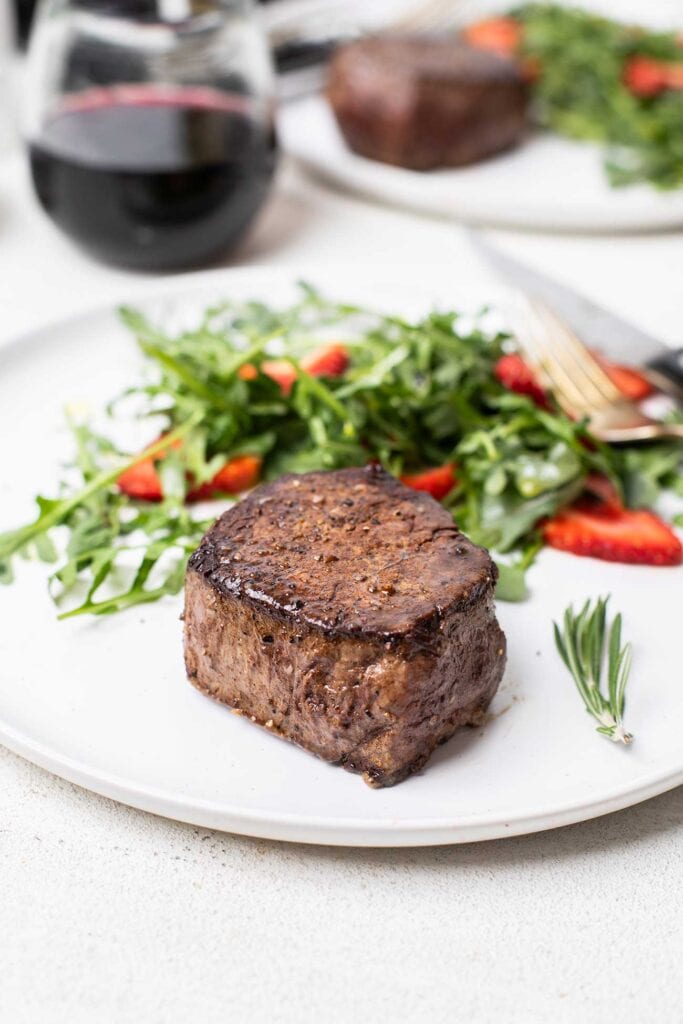 A filet mignon steak shown resting prior to cutting.