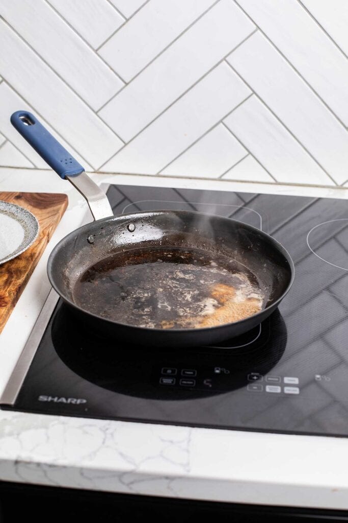 A skillet with brandy simmering.