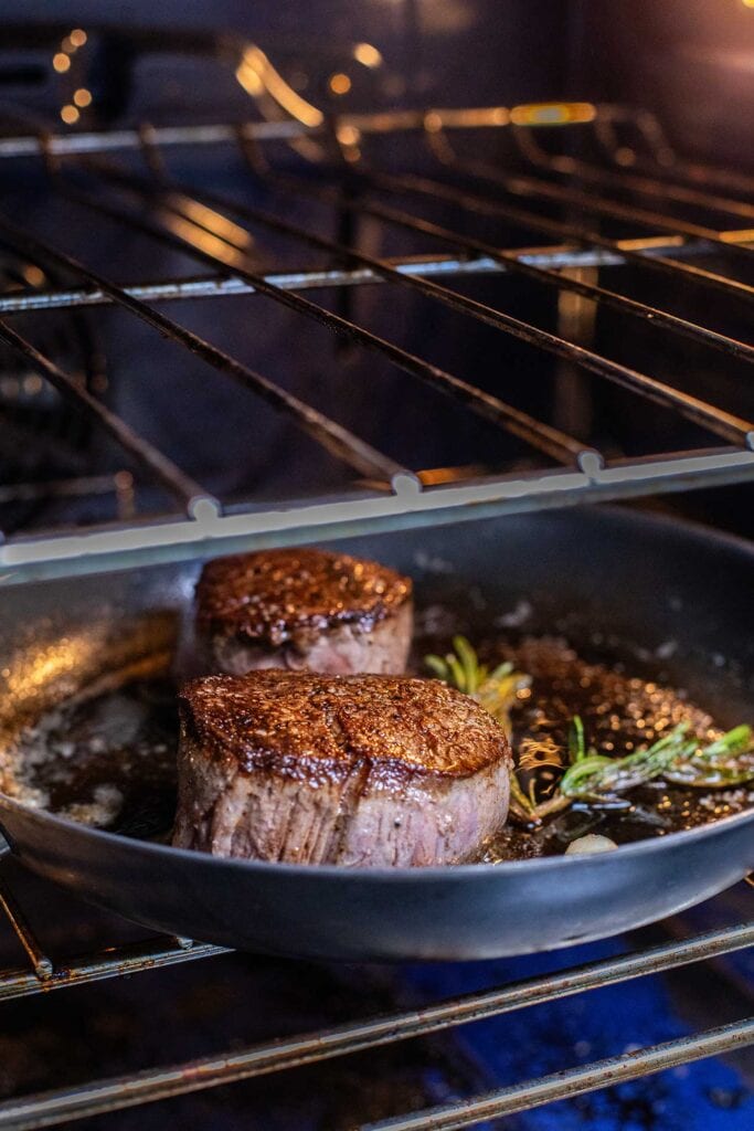 Add the skillet to the oven and allow the steaks to come up to temperature.