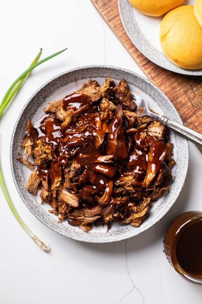 Pulled pork drizzled with bbq sauce.