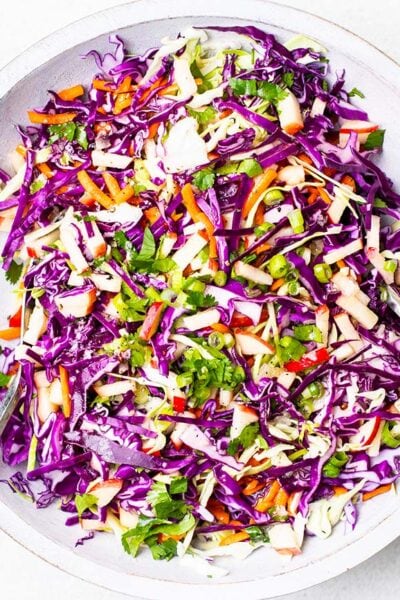 A colorful cabbage slaw made with apples and carrots.