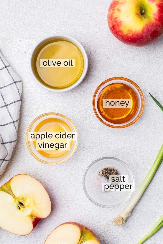 The ingredients needed to make an apple cider vinaigrette dressing.