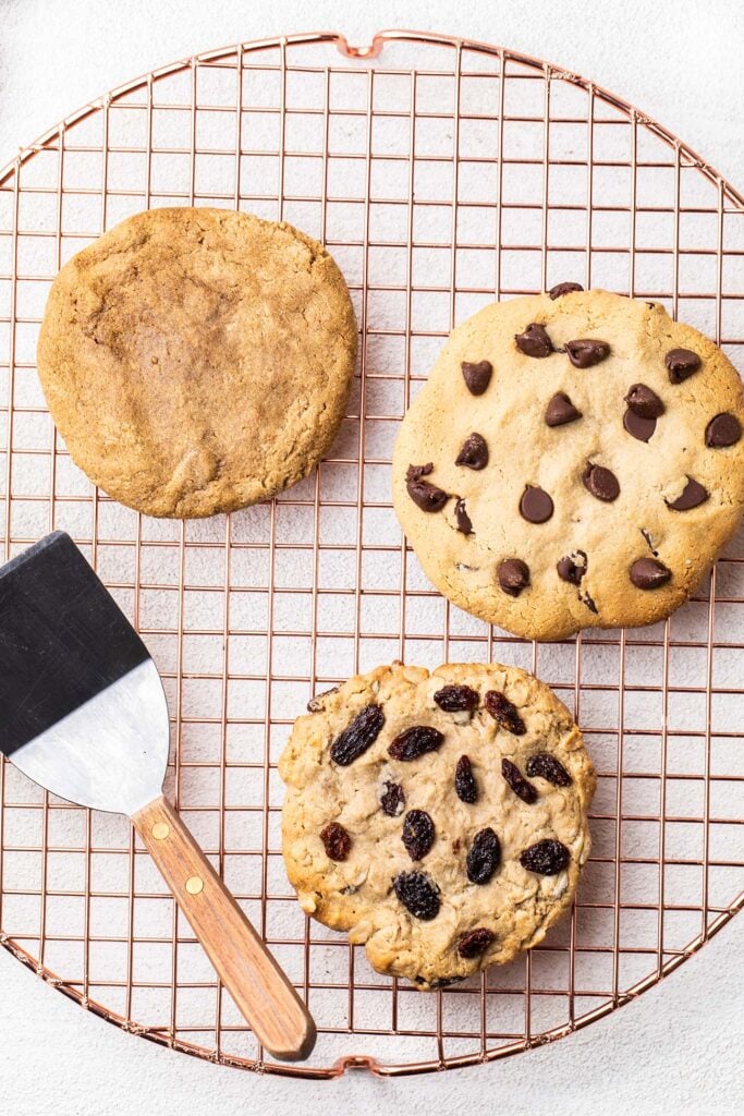 3 flavors of protein cookies on a cooling rack.