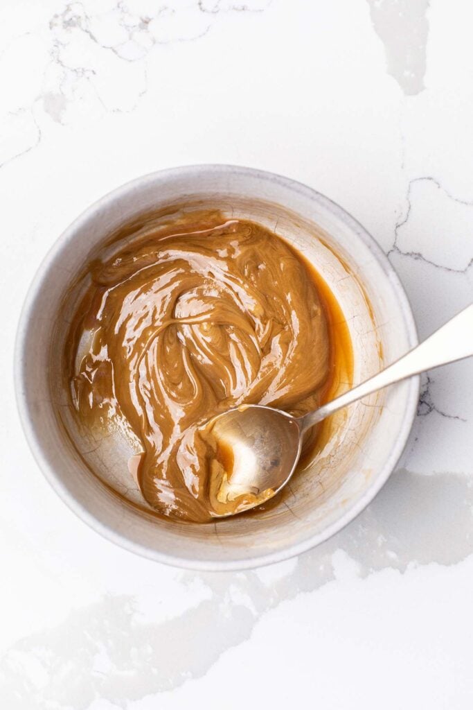 Honey, vanilla, and sunbutter stirred together in a bowl.