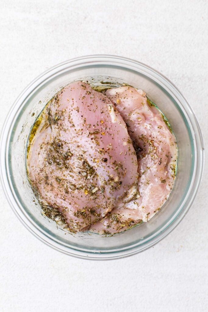 Step 1 shows marinating the chicken breasts in olive oil and herbs.