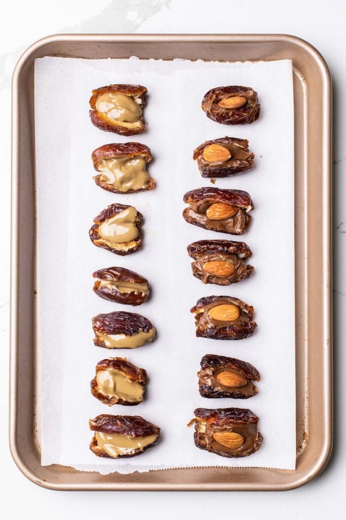 Dates shown filled with nut butter and almonds.