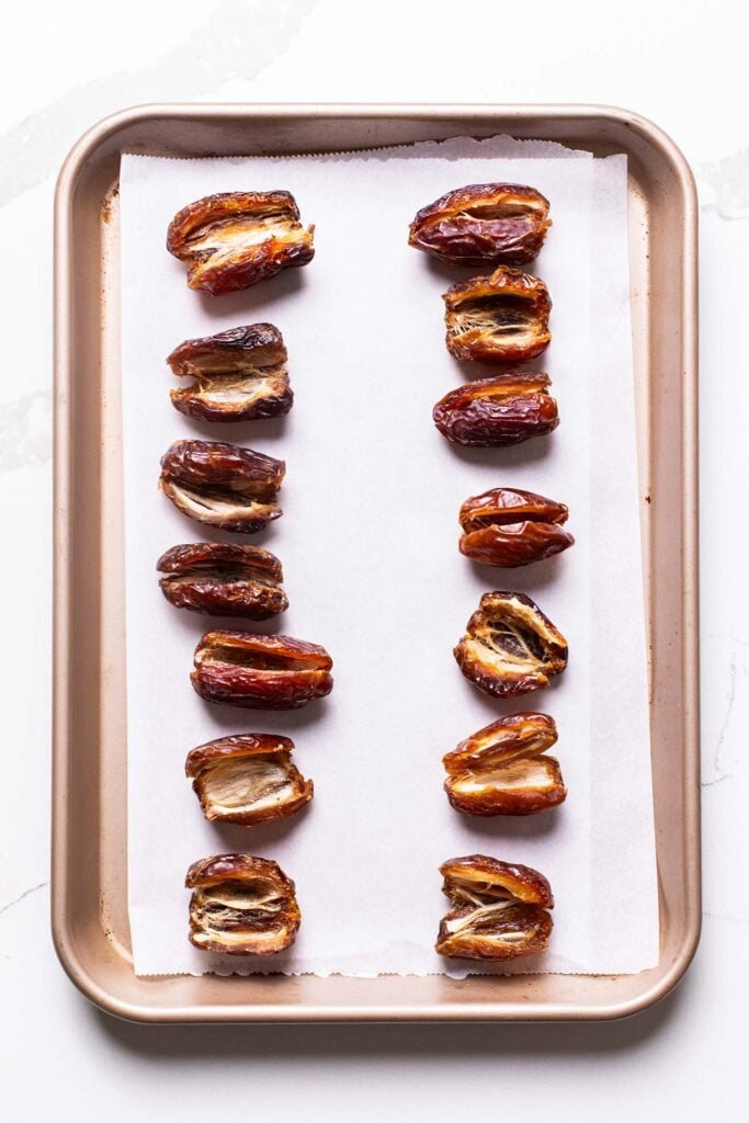 Dates shown pitted and sliced down the middle to open them to stuff.
