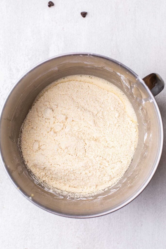 The bowl with the wet ingredients showing almond flour added.