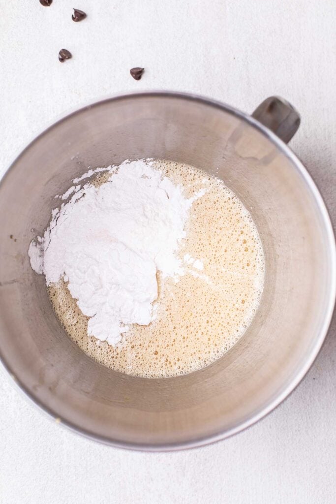 The wet ingredients in a bowl with arrowroot, baking powder, and salt added.