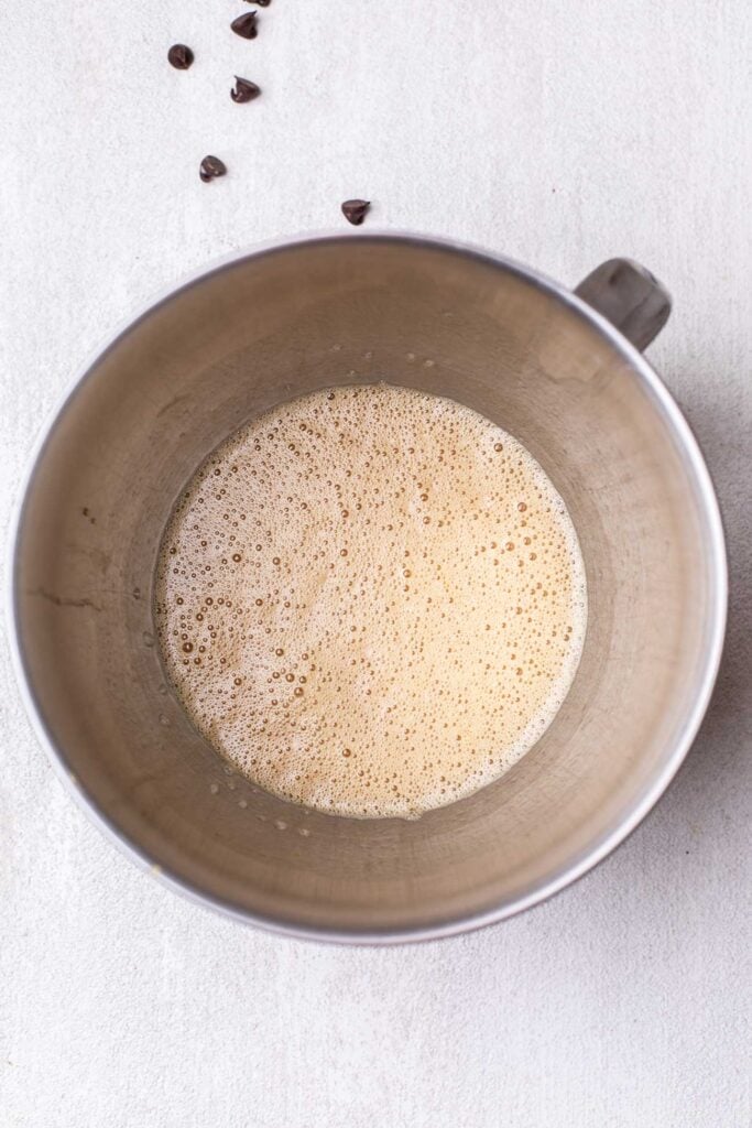 A bowl with eggs, coconut oil, and maple syrup whisked together.