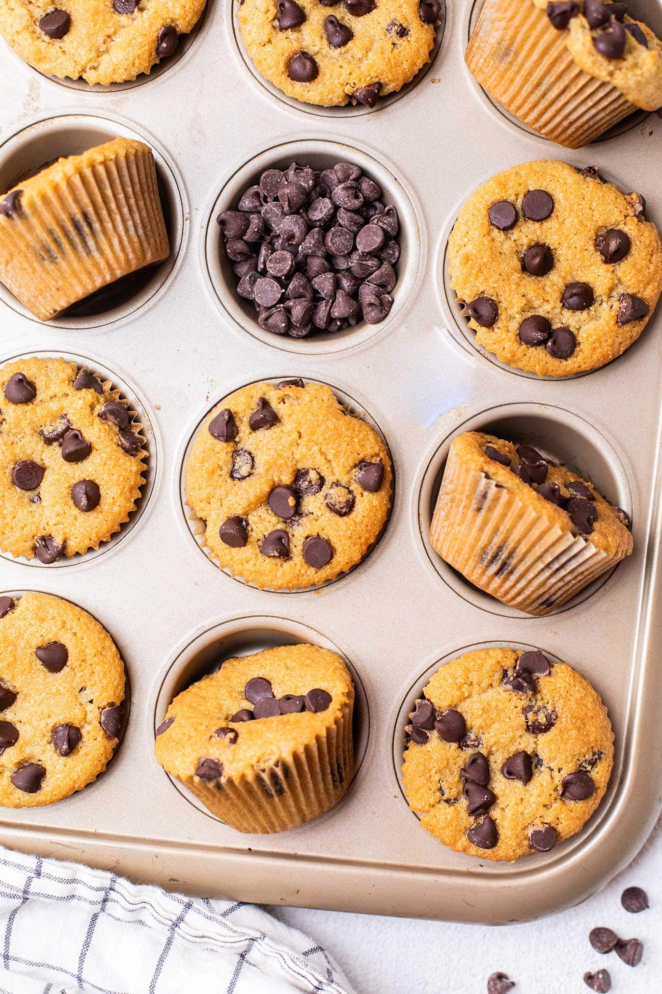 A muffin pan with gluten free chocolate chip muffins in a pan.