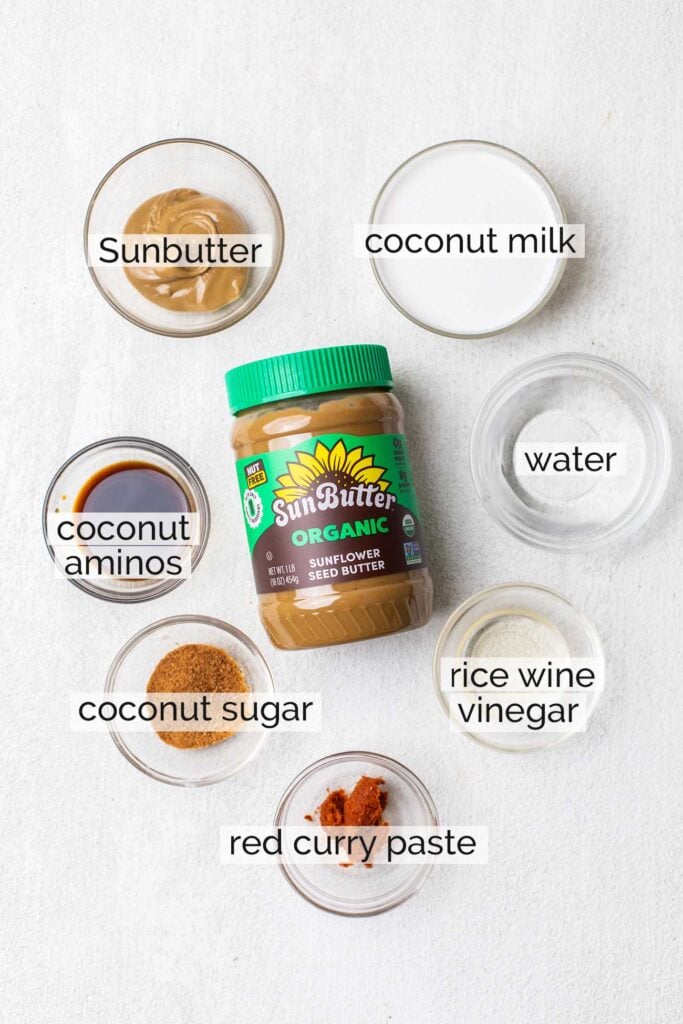The ingredients needed to make a satay sauce shown with labels.