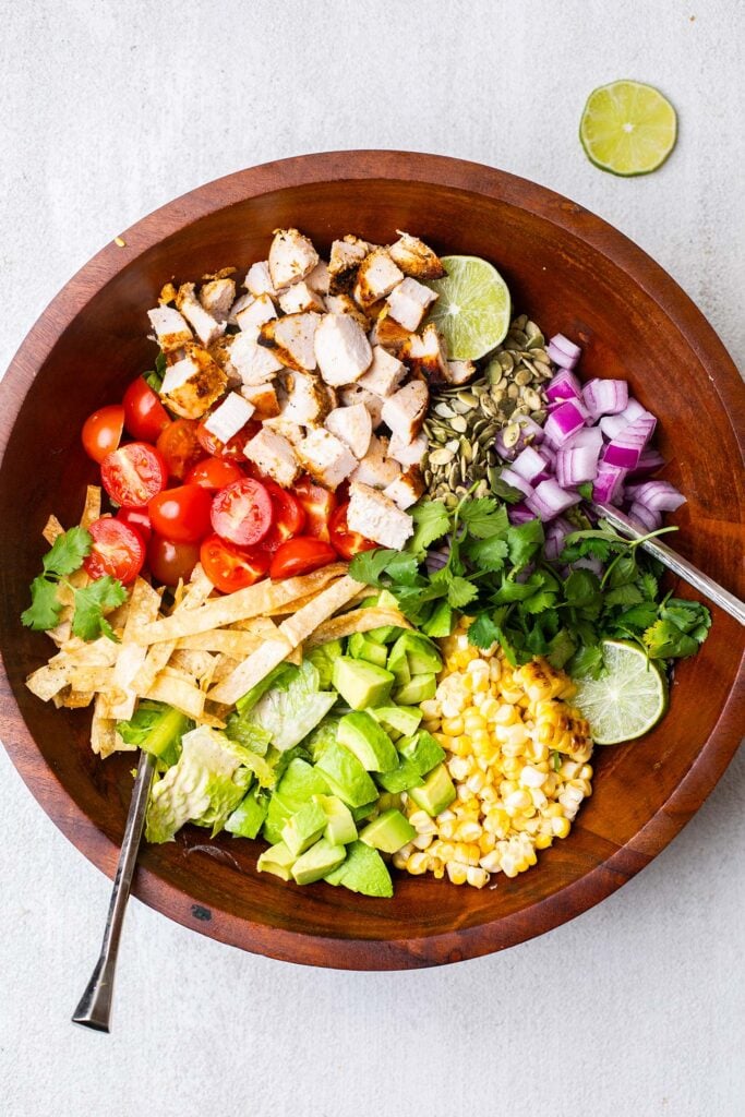A large salad bowl with the toppings shown added to the lettuce.