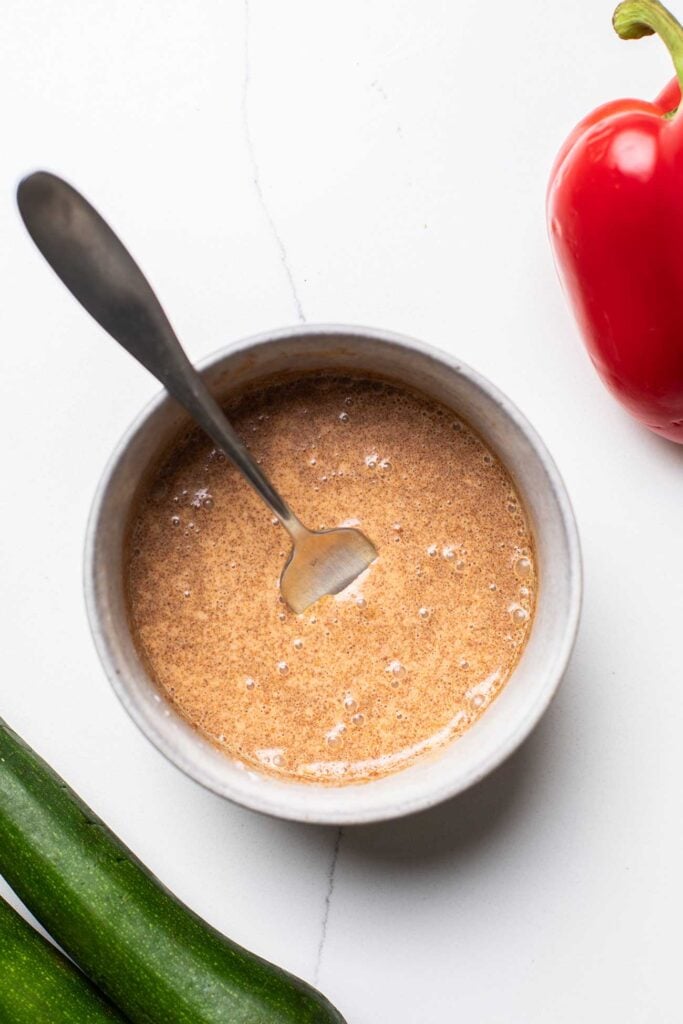 A chicken marinade whisked together in a bowl.