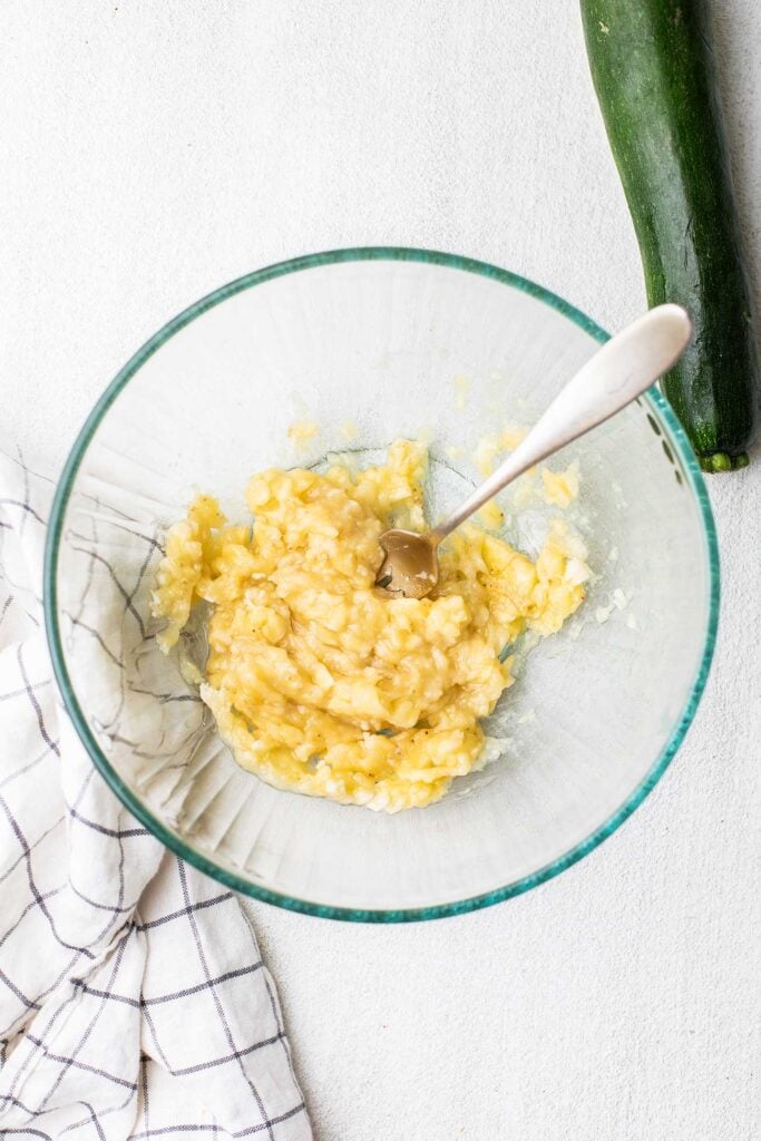 Banana mashed in a mixing bowl.