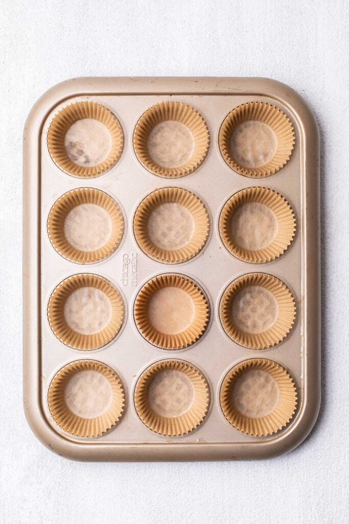 A muffin tin with cupcake liners.