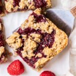 A raspberry bar being picked up by a cookie spatula.