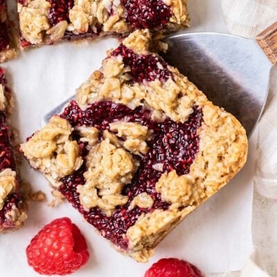 A raspberry bar being picked up by a cookie spatula.