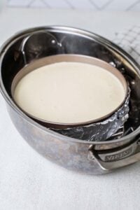 The springform pan placed on a rack in the roasting pan waterbath.
