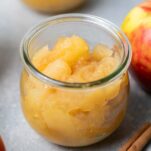 A close up look at a jar of chunky applesauce.
