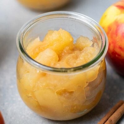 A close up look at a jar of chunky applesauce.