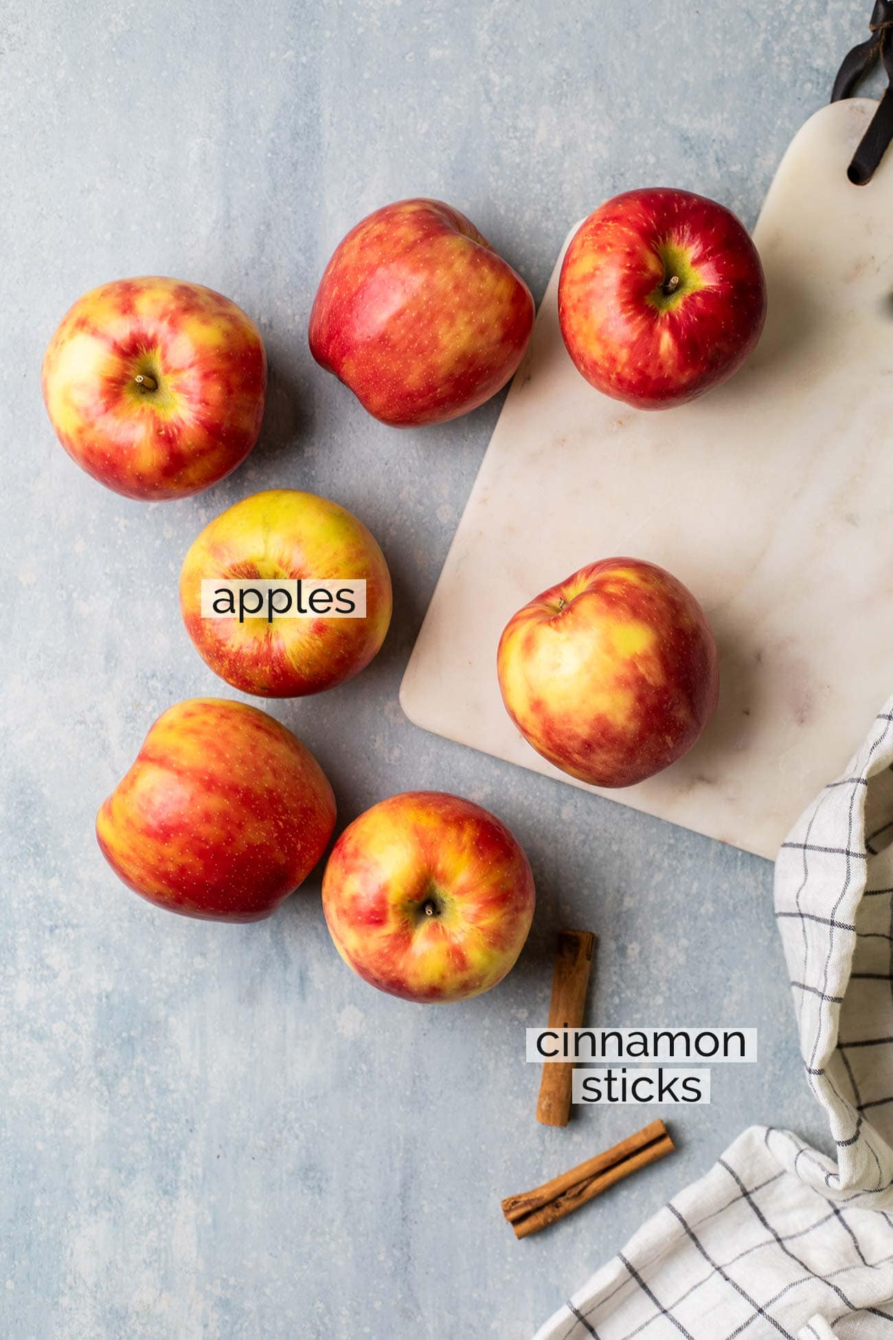 The ingredients needed to make homemade applesauce shown with labels.