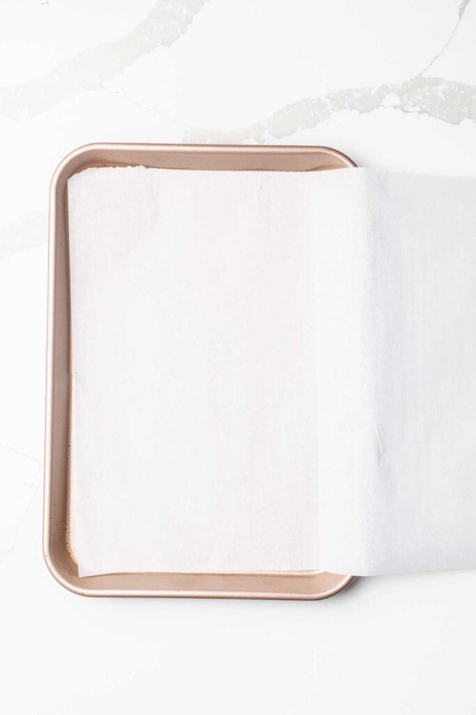 Parchment paper folded on a quarter baking sheet.