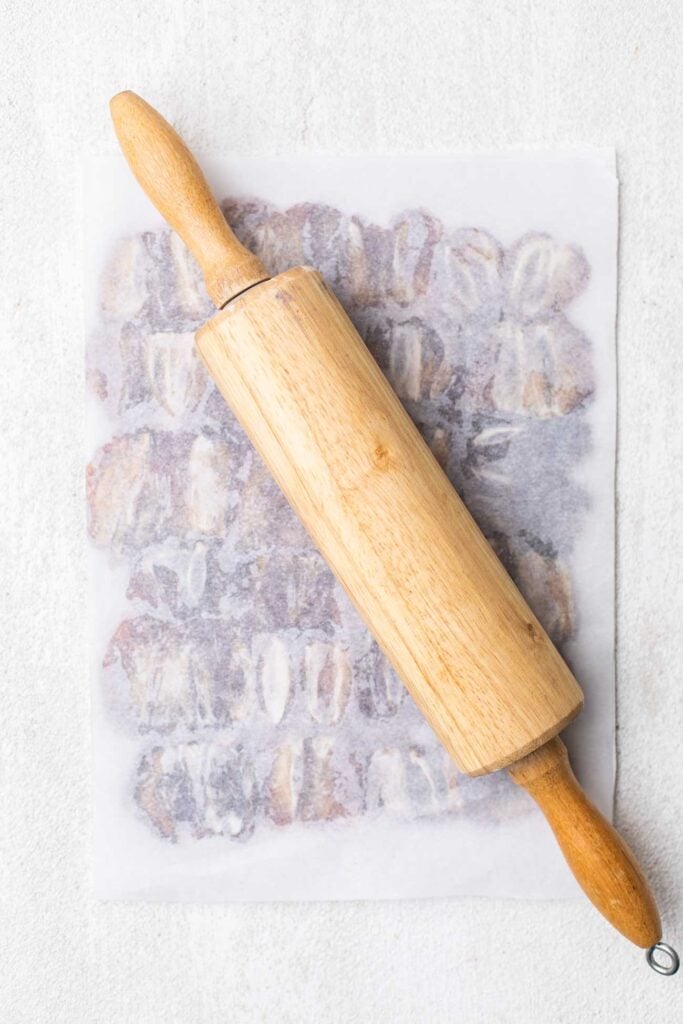 A rolling pin flattening the dates.