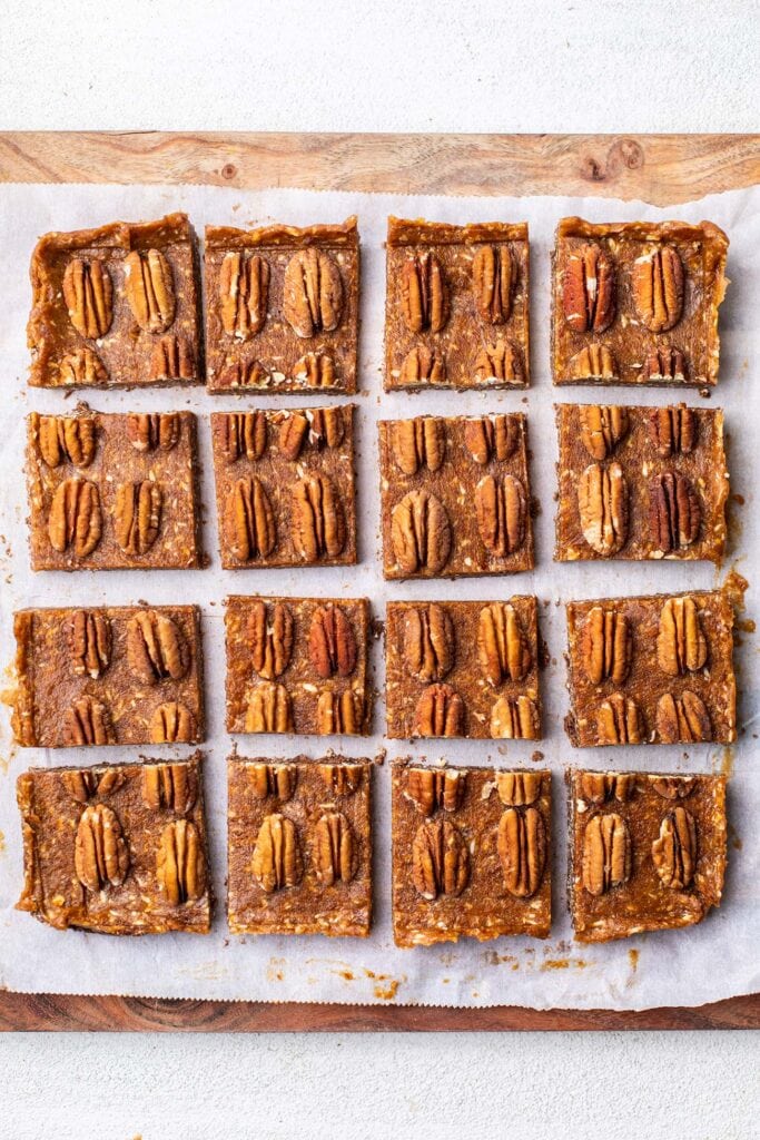 Pecan caramel cookie bars cut into 16 squares.
