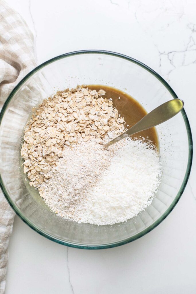The wet ingredients in a bowl with the dry ingredients added in.