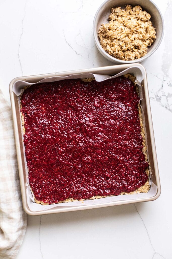 A layer of raspberry jam added to the bottom crust.