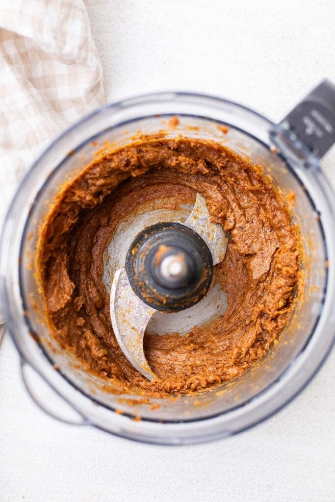 A sticky date mixture in a food processor bowl.