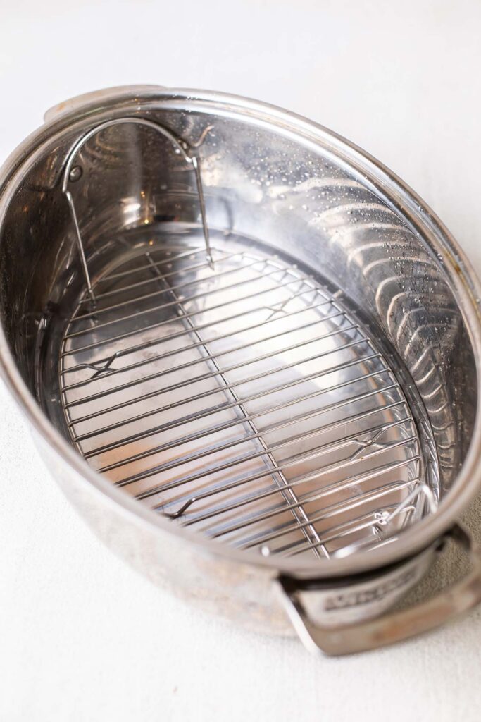 A roasting pan with water and a rack.