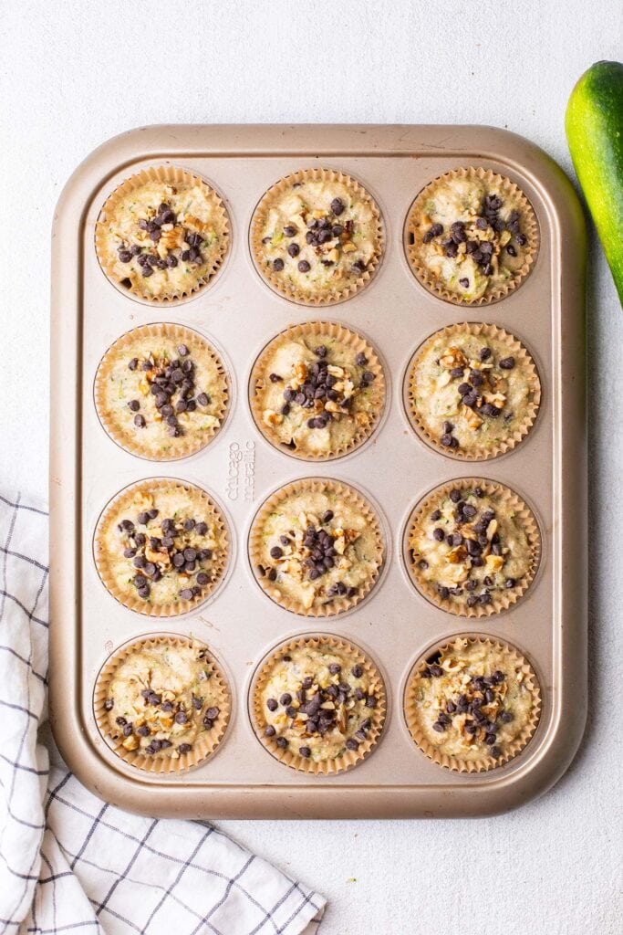 A muffin tin filled with muffin batter.