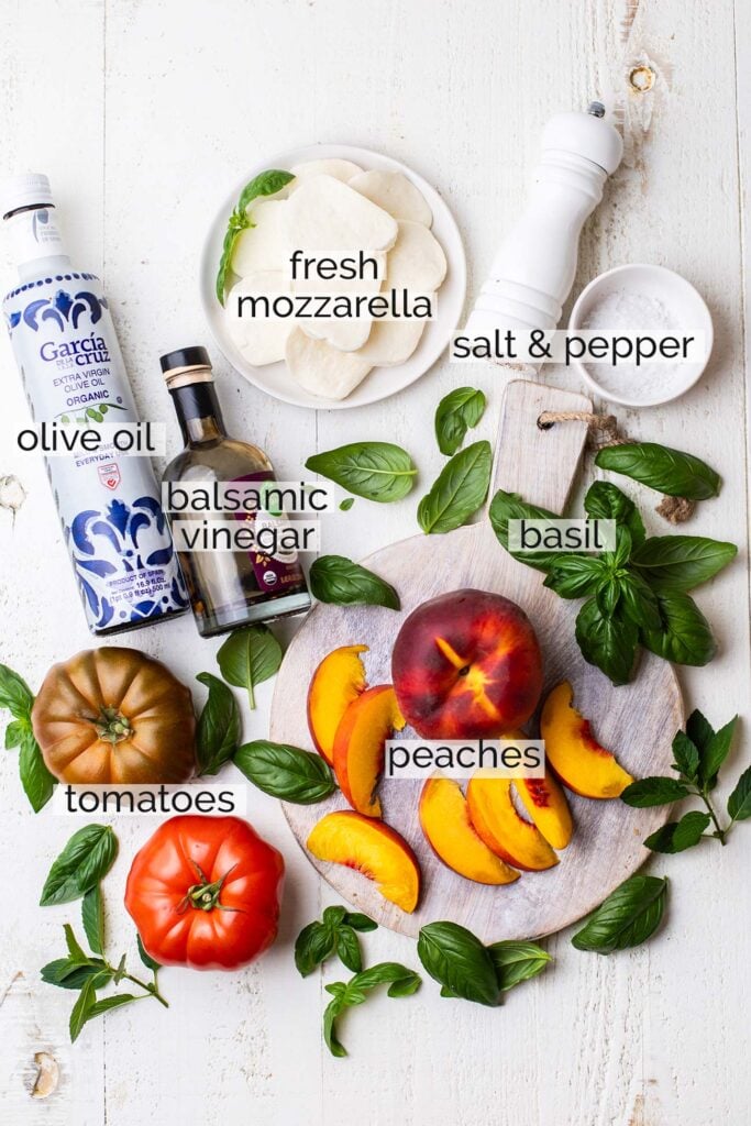 The ingredients needed to make peach caprese shown with labels.