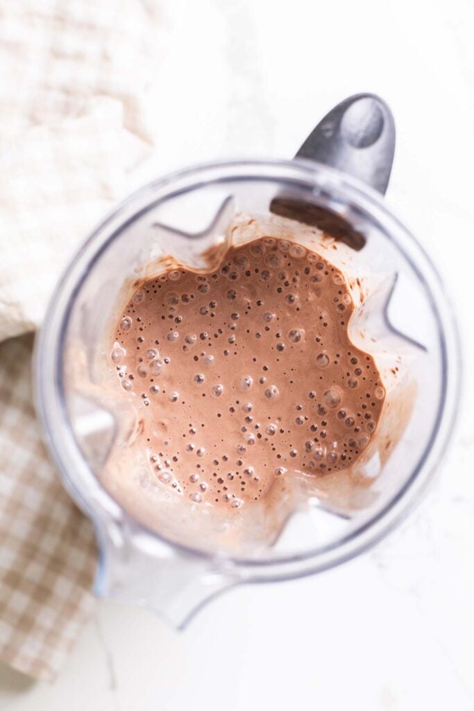 A chocolate ice cream base shown mixed together in a blender.