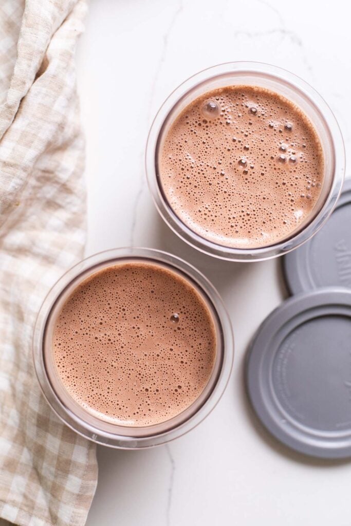 The ice cream base poured into the ninja creami pint containers.