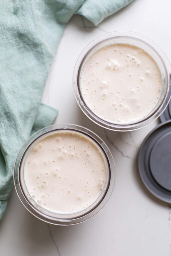 The ice cream mixture poured into ninja creami pint containers.