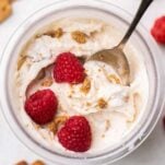 A top down view of a vanilla ninja creami protein ice cream recipe shown topped with raspberries and graham crackers.