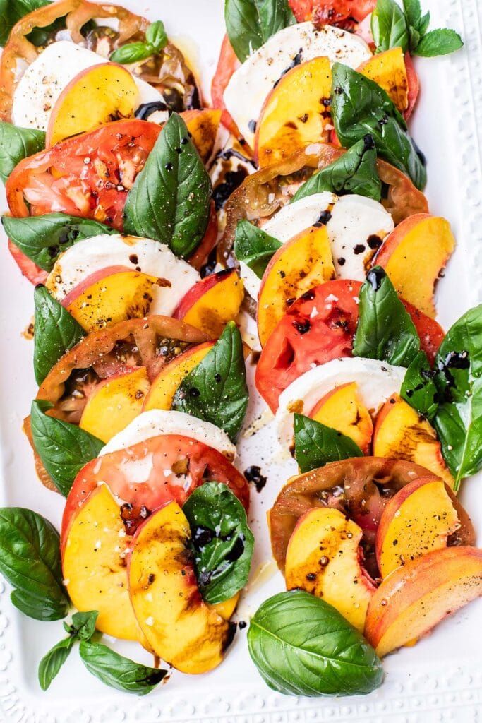 An up close look at the peach caprese drizzled wtih olive oil and balsamic vinegar.