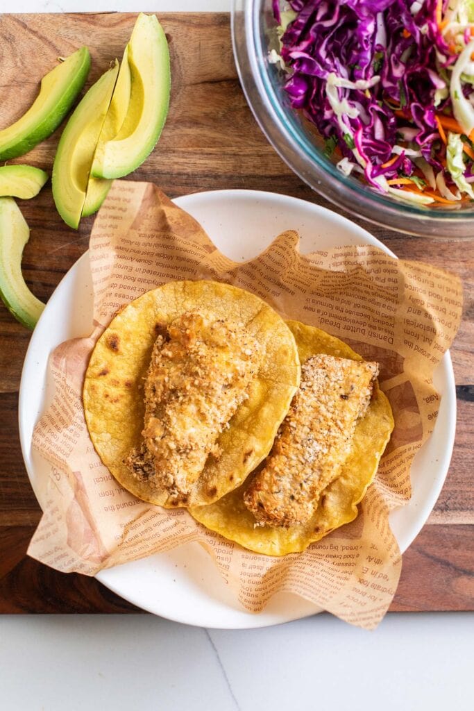 Tortillas shown with pieces of crispy cod.