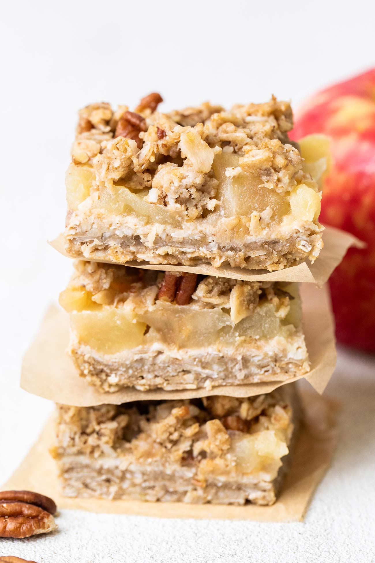 A stack of applesauce oatmeal bars shown with pecans.
