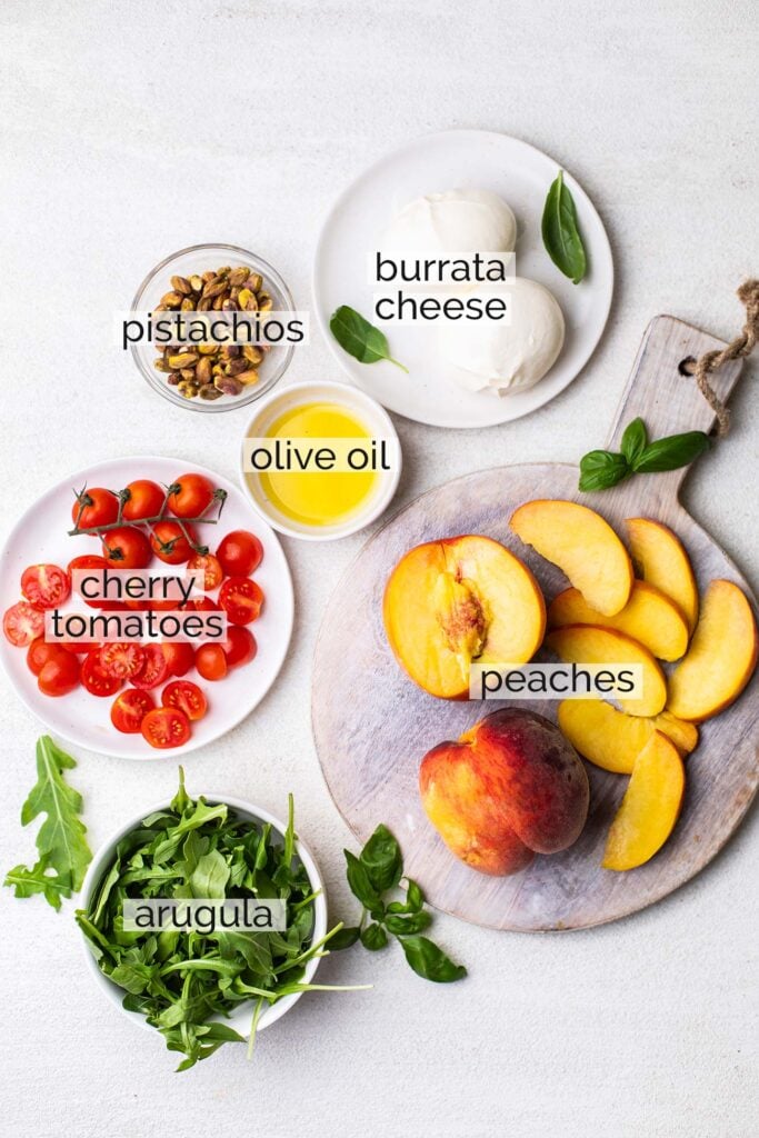 The ingredients needed to make a grilled peach salad with burrata.