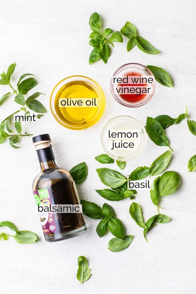 The ingredients needed to make an herbed olive oil.