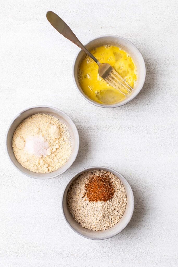 Three bowls with the coating ingredients for the fish.
