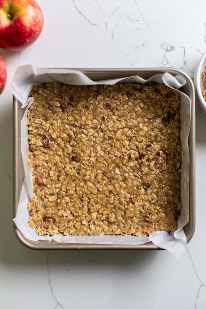 The oatmeal mixture pressed into an even layer in the baking pan.