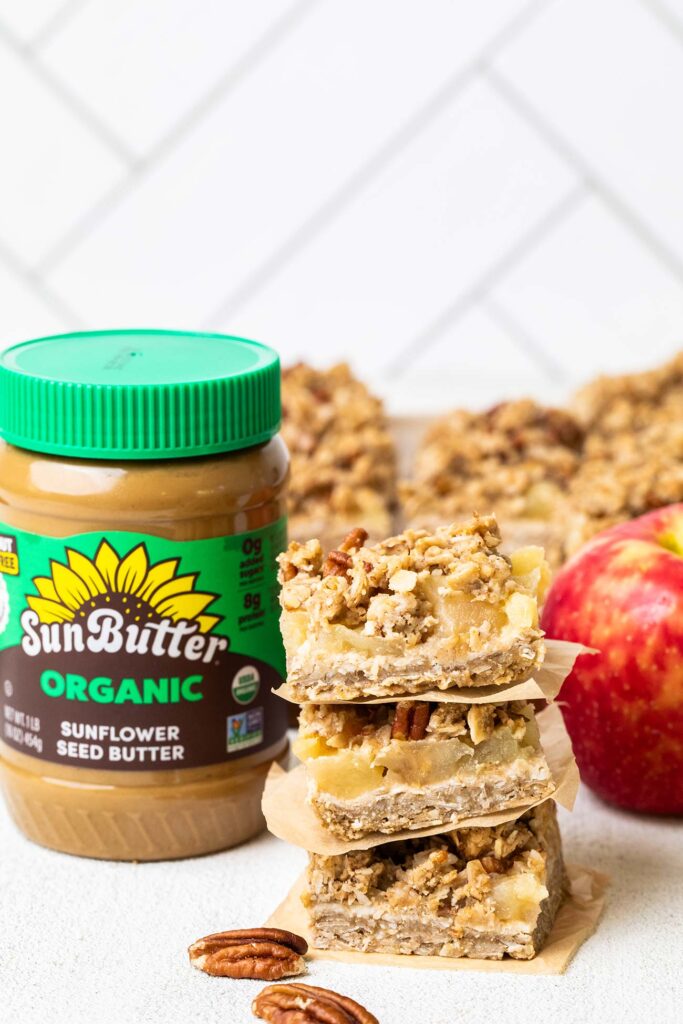 SunButter next to a stack of applesauce oatmeal bars.