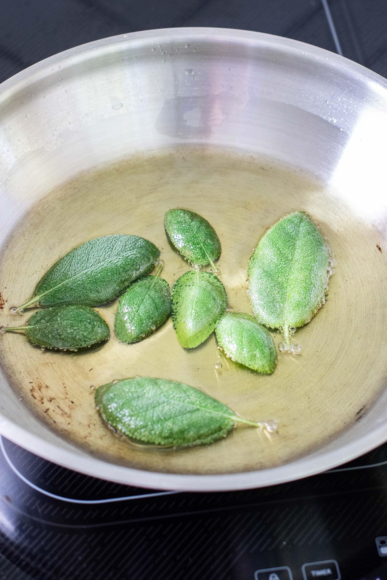 Sage leaves frying in olive oil.